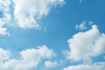 Naklejka na ściany i meble Blue pastel colour sky with white clouds background.