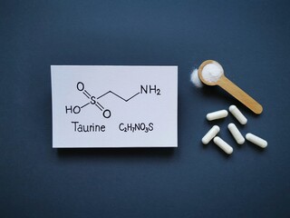 Structural chemical formula of taurine (2-aminoethanesulfonic acid) molecule with taurine pills and...