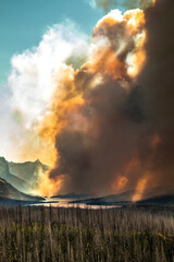 A  dramatic huge clouds of smoke billowing into the sky during a summer forest fire in Reynolds...