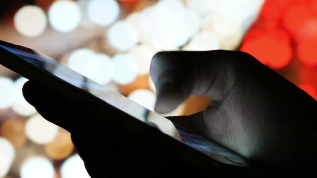Smartphone in the hand, selective focus with shallow depth of field.
