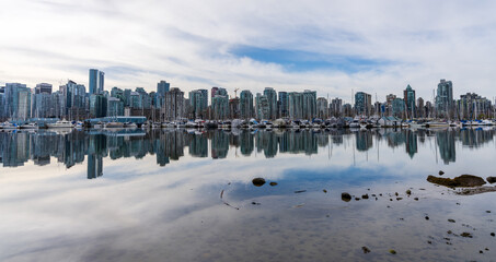 Obraz premium Vancouver City skyline reflected on the water surface. Beautiful cityscape seen from Stanley Park. BC, Canada.