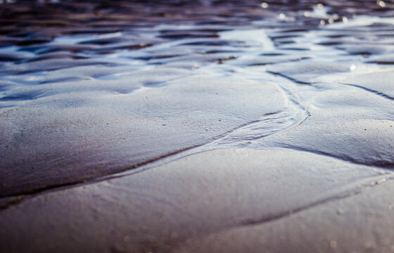 Wet sand close up at Muralha beach in El Puerto de Santa Maria - Cadiz