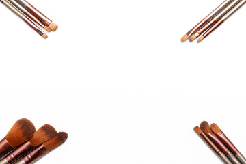 Professional brushes for applying women's makeup. View from above. The tassels are laid out in the corners. An excellent background for an inscription or print.