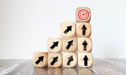 Wood block red arrow pointing the opposite way disruptive from the black arrows on table wooden.
