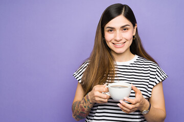 Portrait of a latin woman drinking a cup of coffee