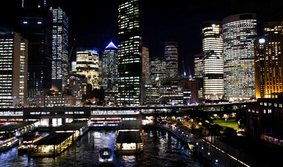 Night view of Downtown Sydney Skyline.  Illuminated Highrises and Office Towers. Sydney Ferry wharf area.