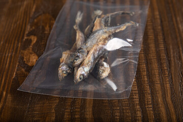 Dried and smoked herring fish in vacuum sealed plastic packaging