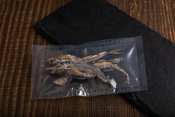 Dried and smoked herring fish in vacuum sealed plastic packaging