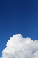 White soft cloud in the blue sky. Heavenly vertical background