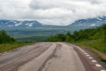 Empty asphalt road in the middle of the mountains in the wild