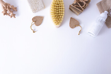 Bath accessories made of natural material, a set of zero waste for the bathroom, soap, cream, a wooden brush on a white table. SPA treatments for youth and beauty.