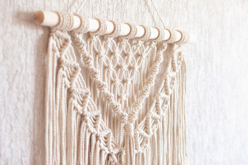 Close-up of hand made macrame texture pattern. ECO friendly modern knitting DIY natural decoration concept  in the interior.  Handmade macrame 100% cotton. Female hobby.