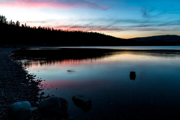 dramatic, peaceful and  serene summer  sunset photo of Lake McDonald in Glacier National Park in. Montana.
