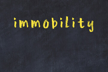 Black chalkboard with inscription immobility on in