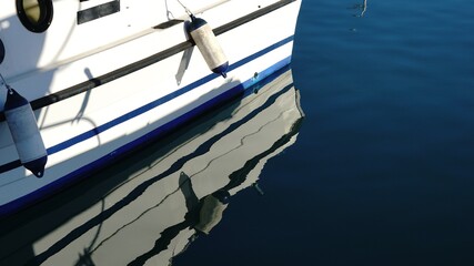 recreational boat reflection in the harbor calm water