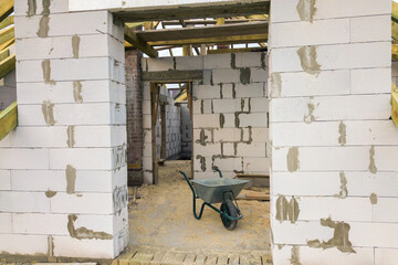 Interior of a private house with aerated concrete brick walls and wooden frame for future roof.