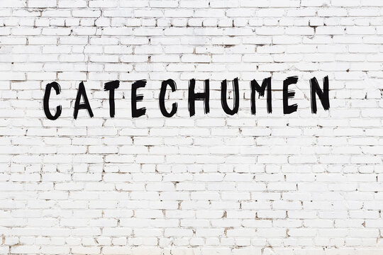 Inscription catechumen painted on white brick wall