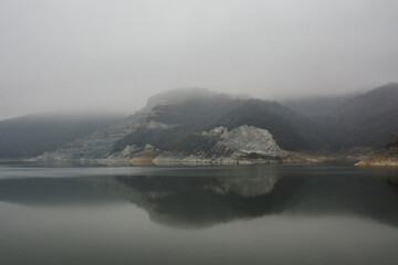 View on a lake in the mist