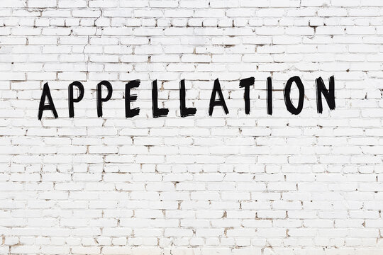 White wall with black paint inscription appellation on it