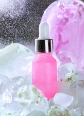 abstract background with bokeh, spray, serum with pipette  and ice shards. Skincare, natural medicine,  organic skin care products.