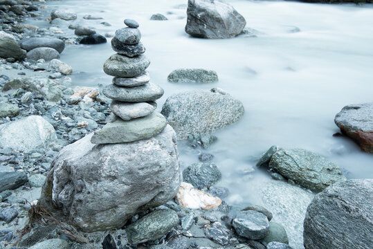 Pile And Stones Perfectly Balanced On The Shore Of A River