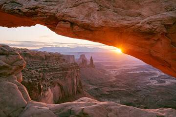 Washer Woman formation at sunset seen through the Mesa Arch in Canyonlands National Park.