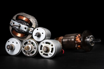 Small electric motors for driving domestic appliances. Electric devices stacked on a table.