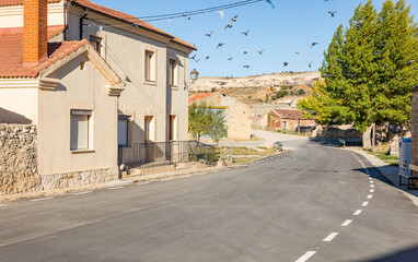a paved road going through Mino de San Esteban village, province of Soria, Castile and Leon, Spain