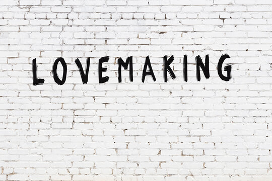 White wall with black paint inscription lovemaking on it