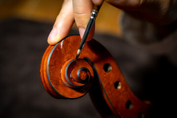 young Chinese violin maker at work in her workshop