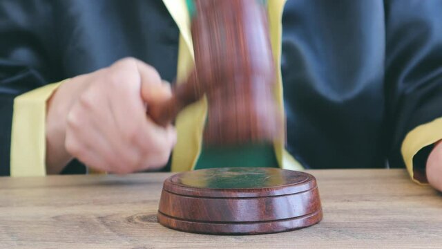 Woman lawyer working with contract papers and wooden gavel on tabel in courtroom. justice and law ,attorney, court judge, concept.