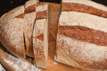 Fresh bread on a wooden board, close-up.
