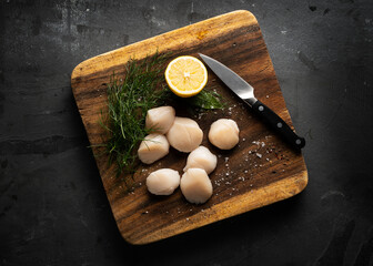 raw scallop on a wooden board 