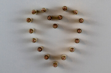 5.56mm bullets arranged in the shape of a heart lit from both sides