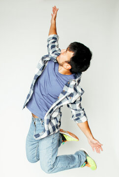 young pretty asian man jumping cheerful against white background, lifestyle people concept isolated