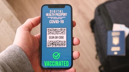 Man using smartphone with digital health passport, traveler worried about COVID-19 testing and vaccination - Powered by Adobe
