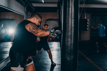 Obraz na płótnie Canvas Horizontal view of handsome sporty man training boxing