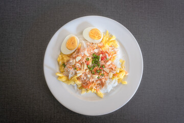 Thai rice noodles with pineapple and coconut milk the delicious of traditional food served on white plate in Thai name is Kanom Cheen Saw Num.