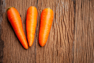 fresh carrot on old wooden background, copy space