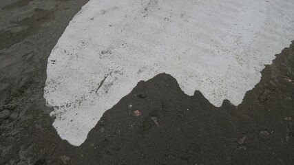a shape of sand on the concrete 