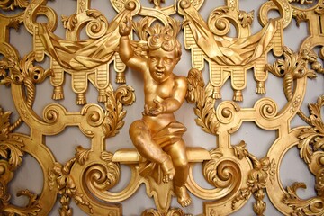 Golden Cupid's statue and the golden background in Storkyrkan church.