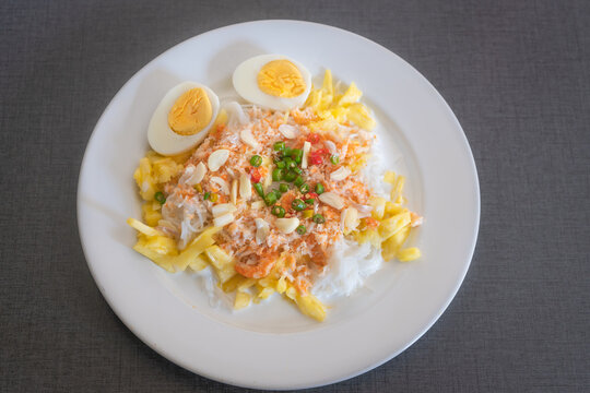 Thai rice noodles with pineapple and coconut milk the delicious of traditional food served on white plate in Thai name is Kanom Cheen Saw Num.