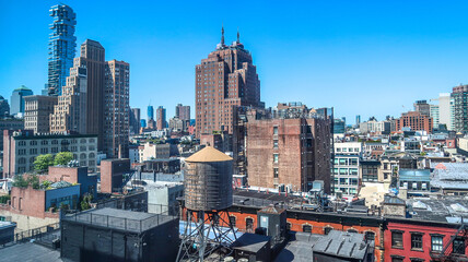 Roof view to rich city fabric of new and old, tall and low contrasting building structures and...