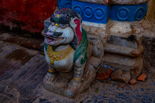 Stone statue of lion located in Bungamati, Nepal just opening the entrance to Rato Machindranath temple
