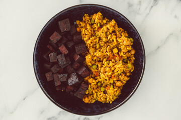 vegan asian fried rice with nutritional yeat and marinated tofu cubes, healthy plant-based food