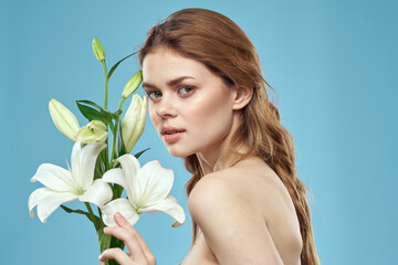 Attractive Lady white flowers blue background portrait cropped view