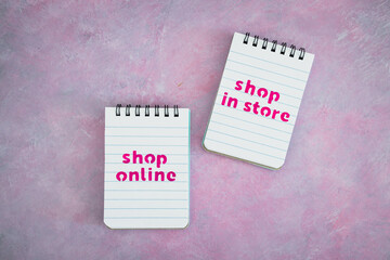 shop in store vs shop online texts on notepads, competition and retail industry
