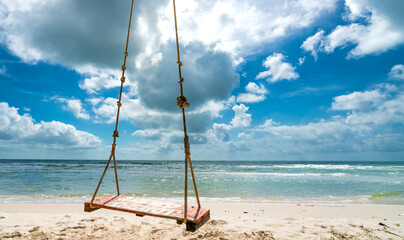Swing attached to a palm tree in the idyllic Sao beach in Phu Quoc island, Vietnam. Sao beach is one of the best beaches of Vietnam.