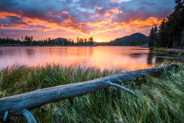 dramatic and vibrant summer sunrise in Sprague Lake in Rocky Mt National Park 