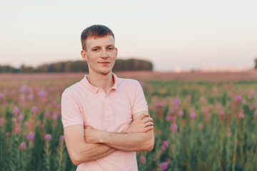 a man walks through a flower meadow. Love and spring blooming